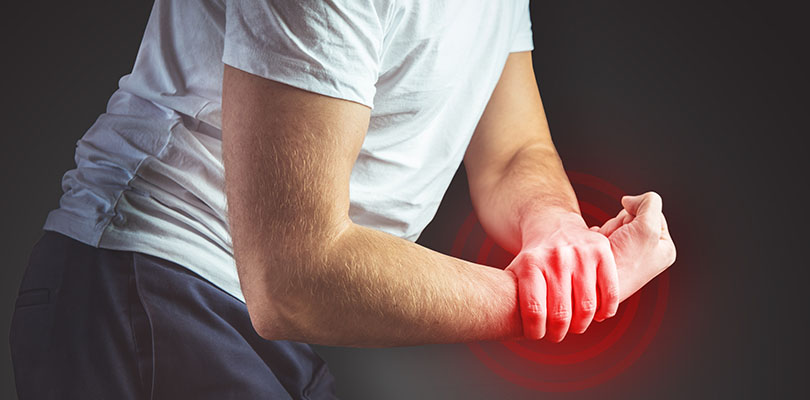 A man is experiencing carpal tunnel syndrome symptoms